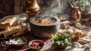 تصویر دیزی سنگی در دیگ سنگی با نان سنگک، ریحان، سماق و ترشی لیته روی سفره سنتی؛ نمایی از آبگوشت سنتی و آیین سرو ایرانی.