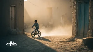 اولین دوچرخه‌سواری بدون کمکی کودک در کوچهٔ خاکی ایرانی با گرد و خاک و تشویق خانواده